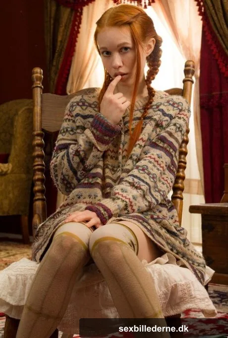Young looking redhead Dolly Little gets naked in over the knee socks